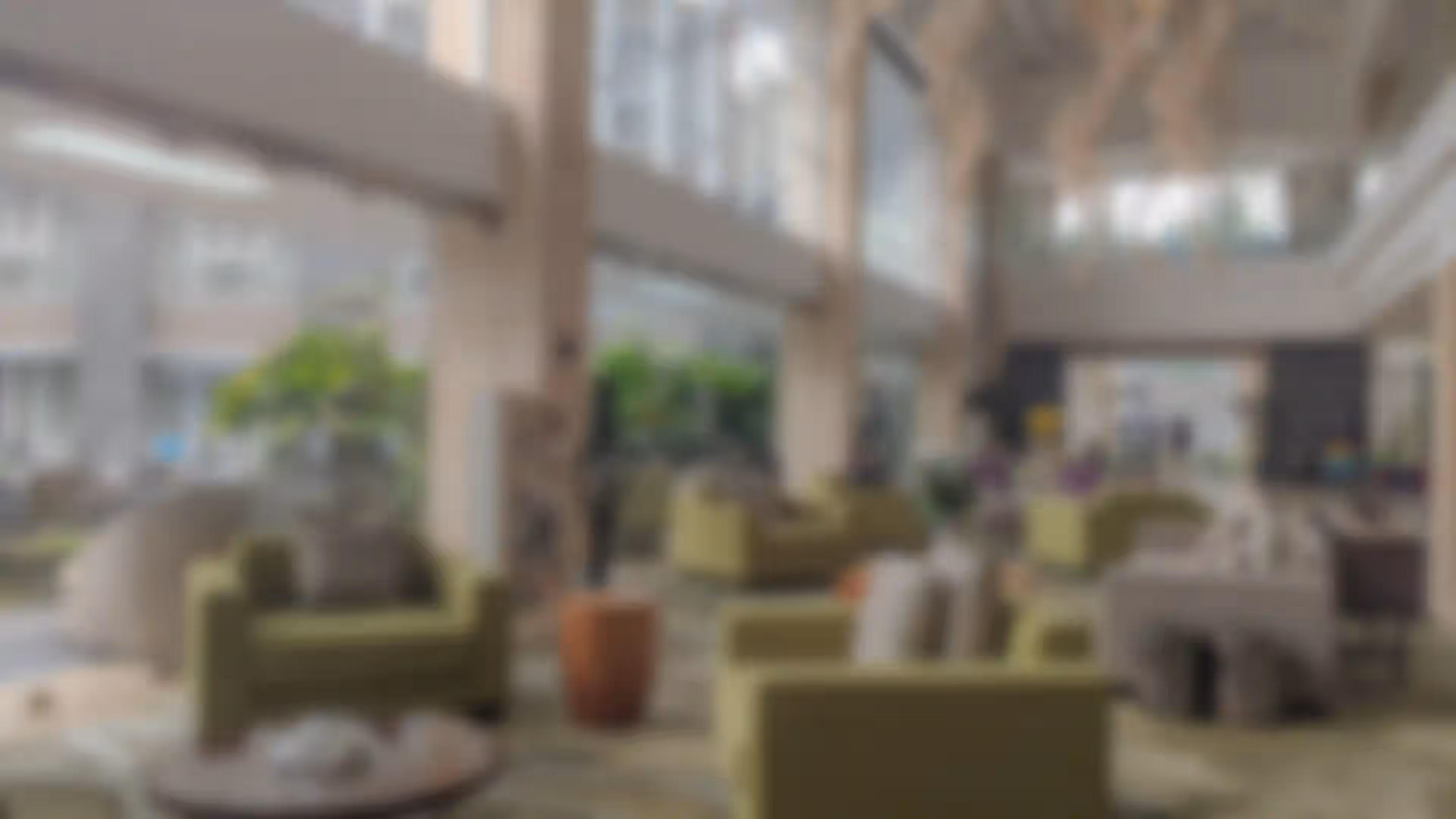 blurred hotel lobby with green sofas